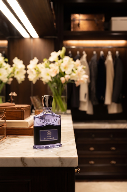 Creed Iris Debonair bottle in an elegant editorial presentation